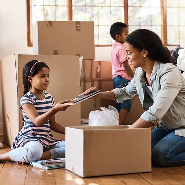 Family packing belongings in boxes