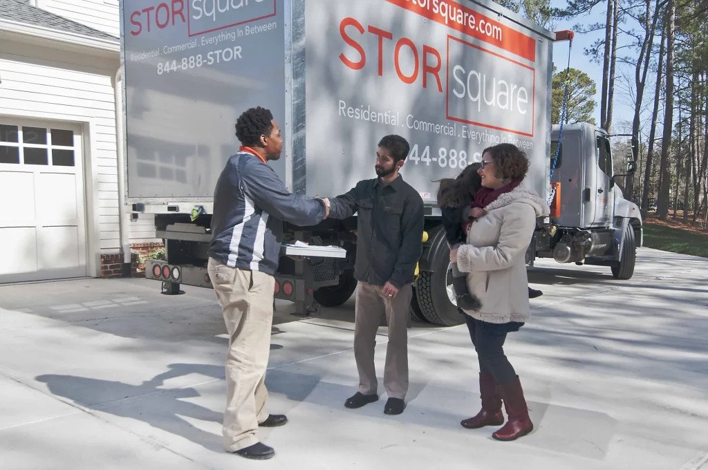 Storsquare employee shaking hands with family outside home