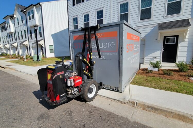 Portable storage container in a driveway showing how mobile storage declutters homes.
