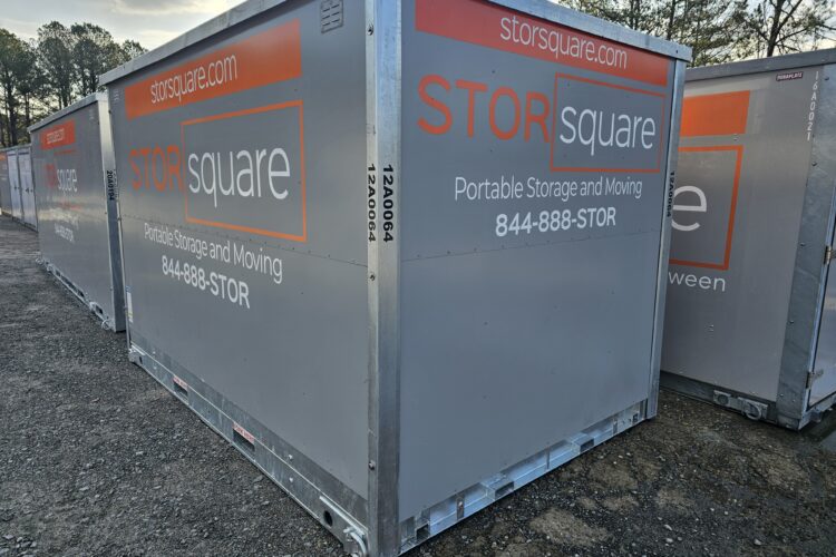 On-site storage containers for roofing materials and equipment lined up on a job site, providing secure, weather-protected storage during active roofing projects.