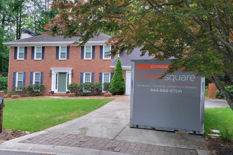 Storage container rentals nearby placed in a residential driveway in Concord, Tennessee during a home decluttering project