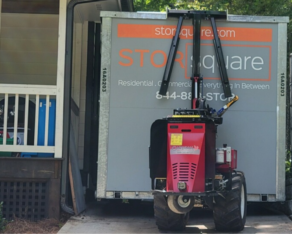 STORsquare portable storage container placed beside a home using specialized placement equipment.