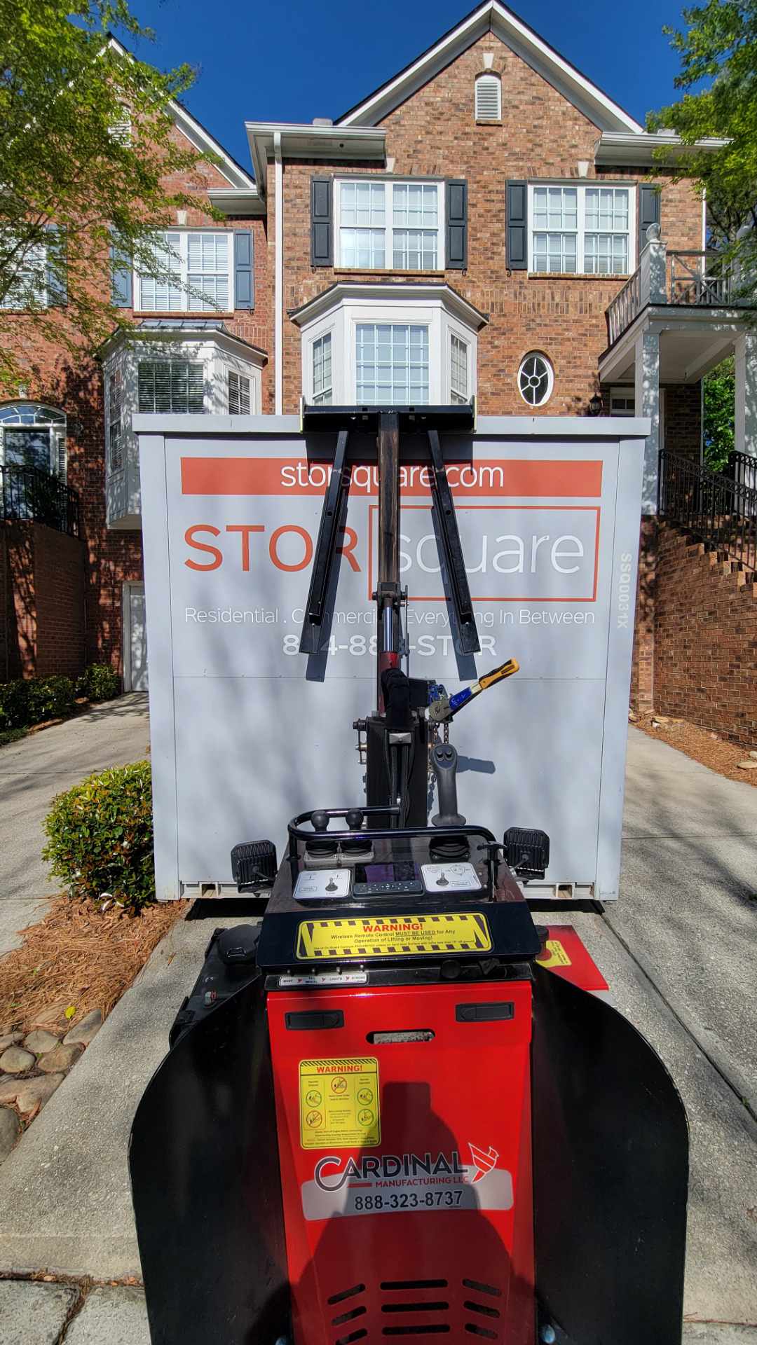 STORsquare portable storage container being precisely placed with no-tilt equipment, part of reliable Tennessee moving solutions.