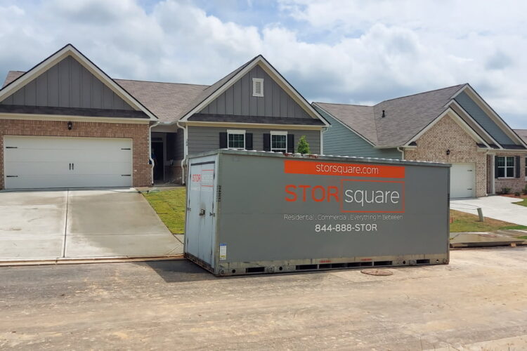 What to pack first during a residential move with self storage containers for rent placed in a driveway for easy access on moving day