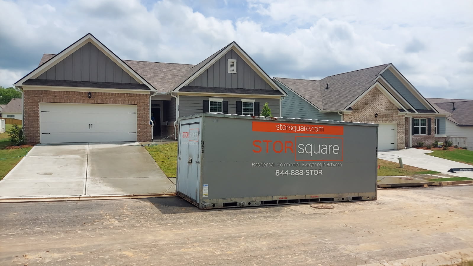 What to pack first during a residential move with self storage containers for rent placed in a driveway for easy access on moving day