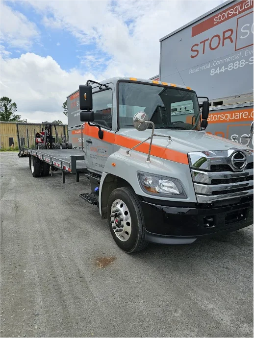 STORsquare flatbed truck prepares long distance moving services with portable storage containers in Central Florida.