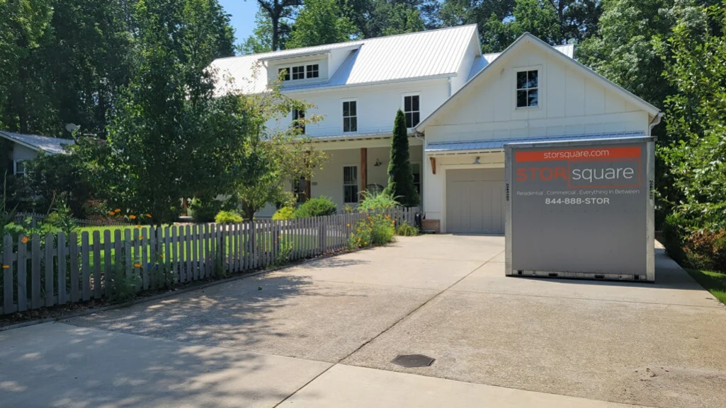 Portable storage during moving placed in a residential driveway, helping homeowners manage a last-week kitchen while preparing for move-out.