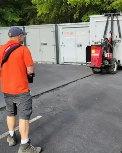 STORsquare interstate moving containers secured in a Southeast storage yard using specialized equipment for long distance moves.