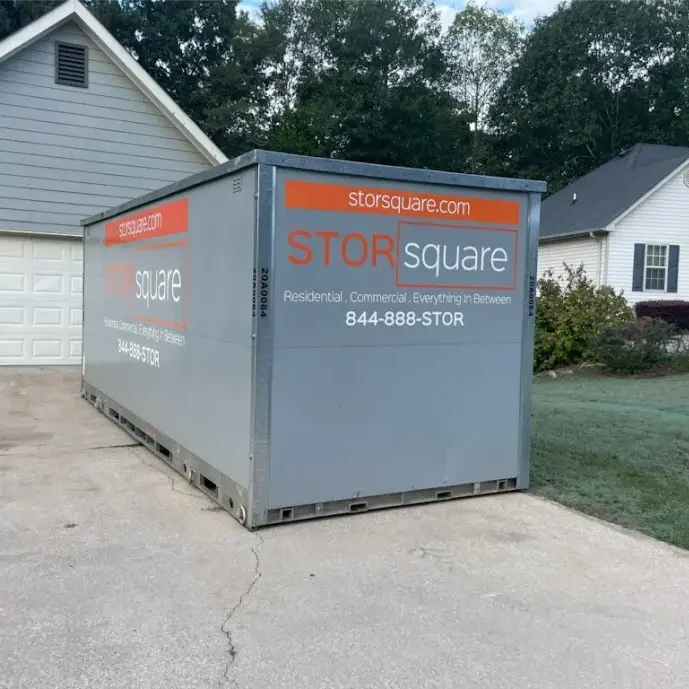 STORsquare portable storage container placed in a residential driveway for flexible loading during a move in Knoxville, Tennessee.