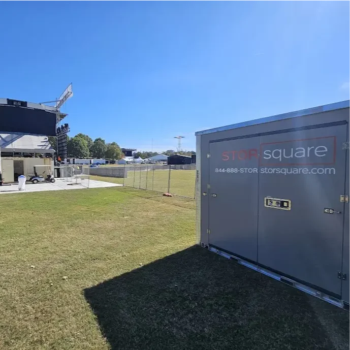 STORsquare portable storage container placed on a grassy event site near staging equipment, set up for temporary storage in Tennessee.