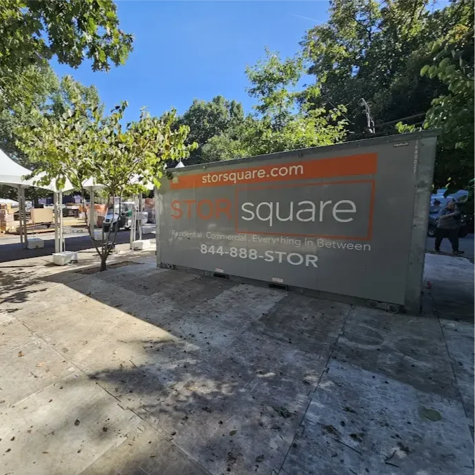 STORsquare portable storage container placed beside tents and equipment at an outdoor event site, used for temporary storage in Florida.