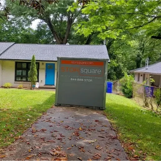 STORsquare portable storage container placed on a residential driveway in front of a single-story home, set up for on-site storage in Tennessee.
