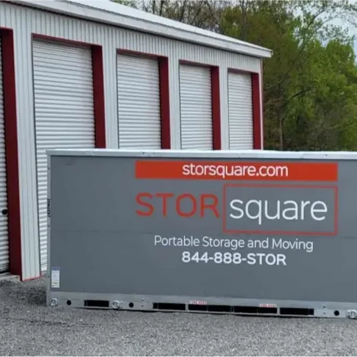 STORsquare portable storage units staged outside a storage yard in Georgia, positioned on gravel near roll-up bays.