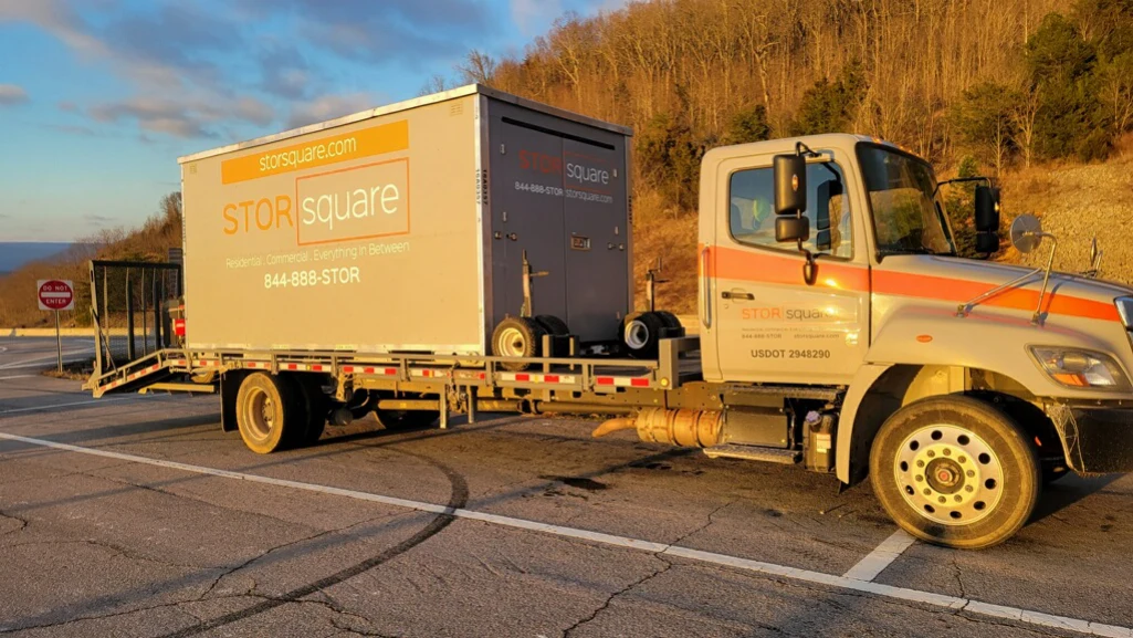 STORsquare mobile storage container being transported for a long-distance move to reduce moving costs.
