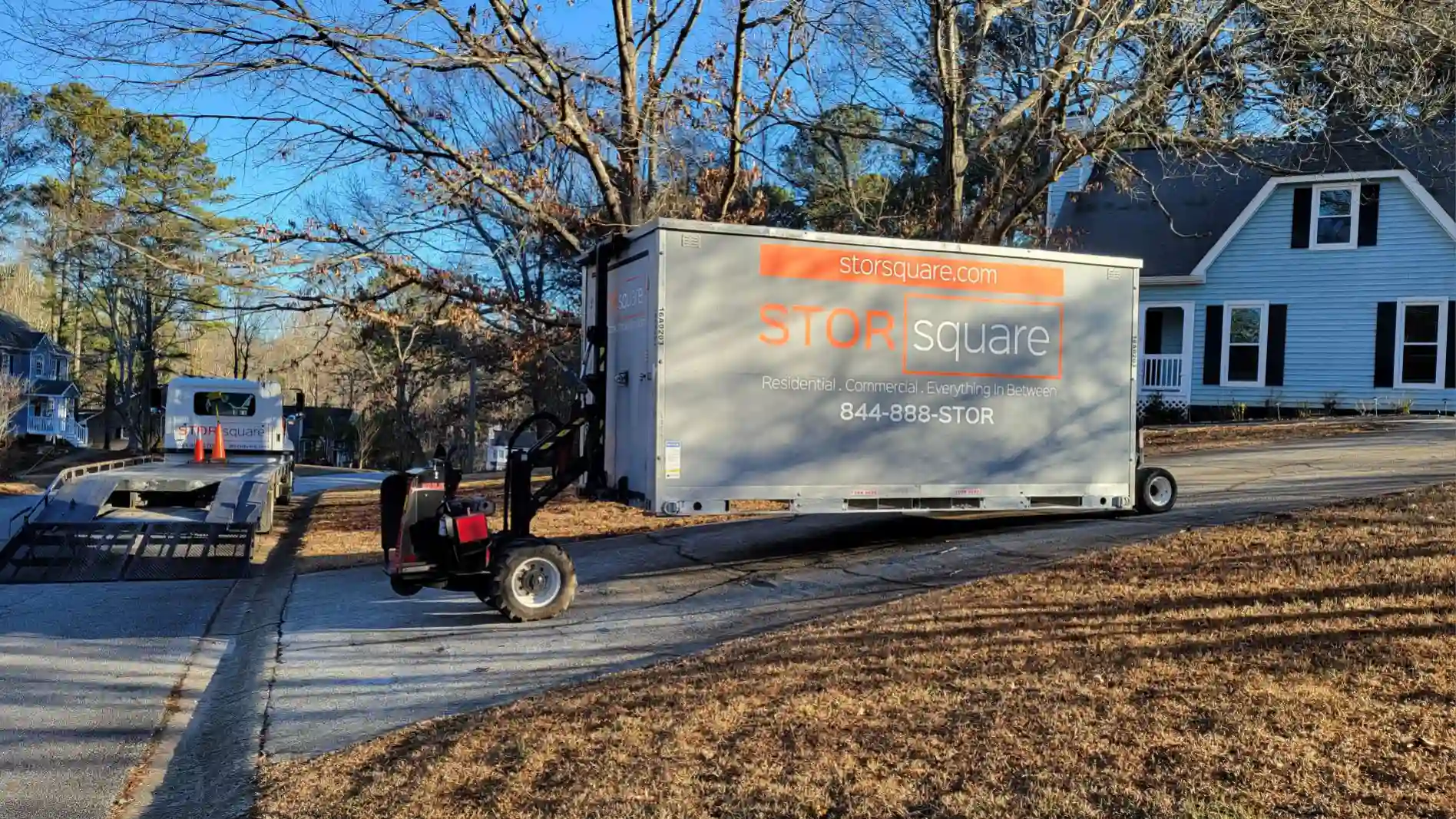 Mobile storage unit being delivered to a residential driveway during a local move in Rockford. mobile storage units moving.