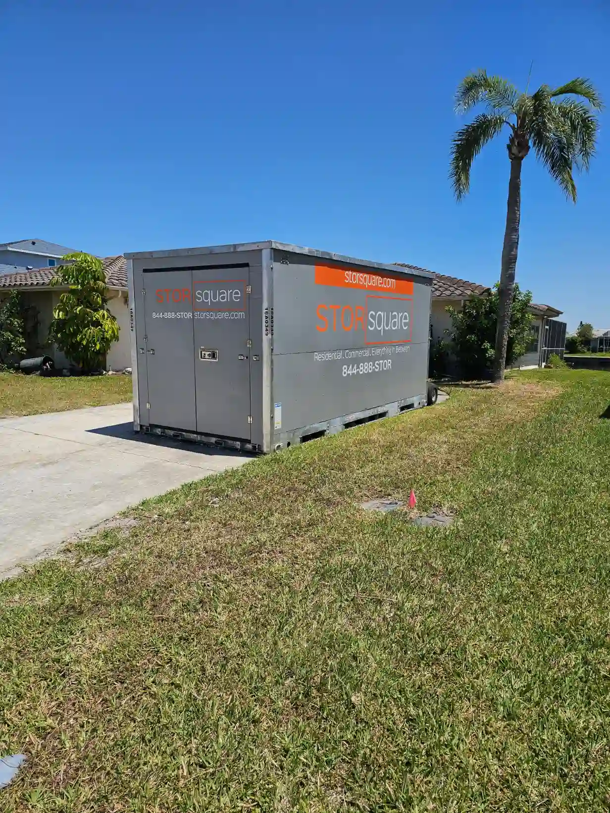 Portable storage container in a residential driveway showing how mobile storage declutters homes during restoration