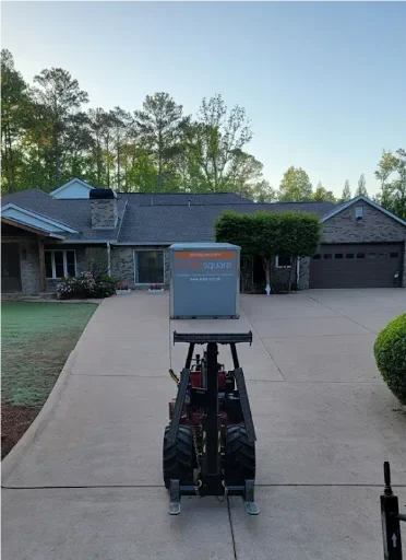 STORsquare portable storage container being delivered onto a residential driveway using precision placement equipment in Brandon, FL.