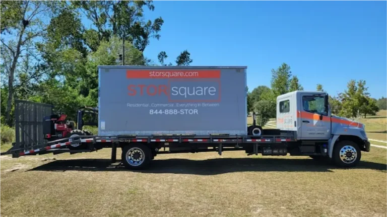 STORsquare mobile storage unit secured on a flatbed truck in Cornelius during transport.