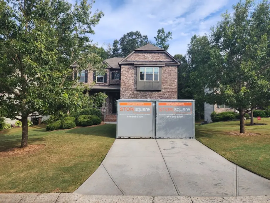 Two STORsquare mobile storage units positioned side by side in an Acworth, GA driveway in front of a brick home.