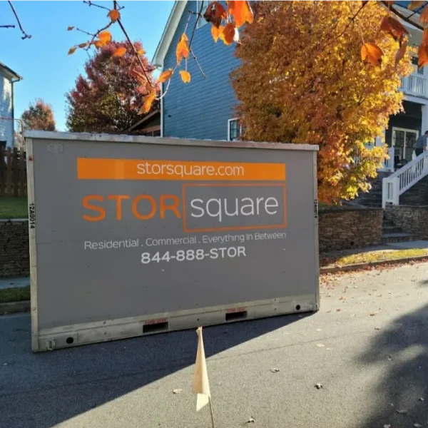 STORsquare portable storage container placed along a residential street in Cornelius with fall foliage and homes visible.
