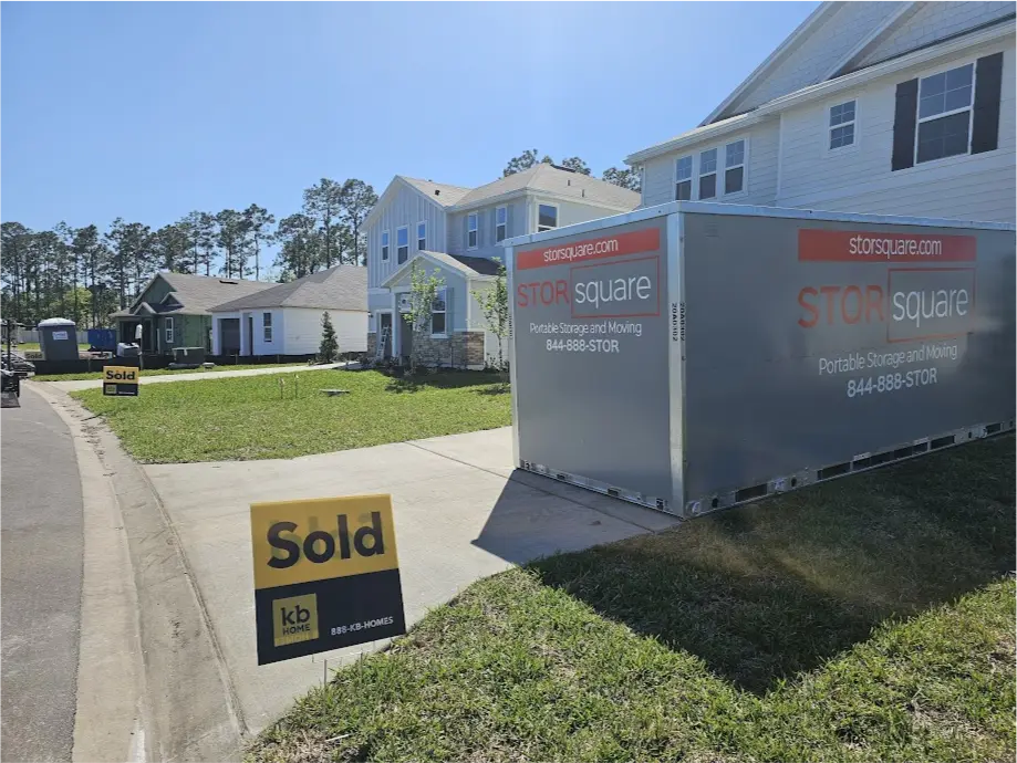 STORsquare portable storage container placed in a residential driveway outside a newly sold home in a Charlotte, North Carolina neighborhood.