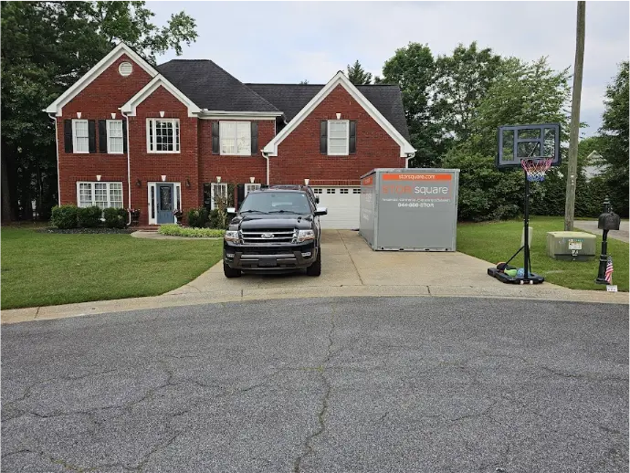 STORsquare portable storage units placed in a residential driveway in Acworth, GA beside a brick home.
