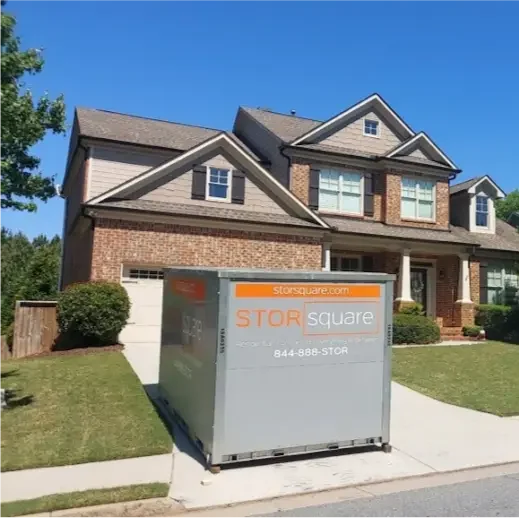 STORsquare portable storage unit placed in a Charlotte, NC residential driveway, offering secure on-site storage for a local move.