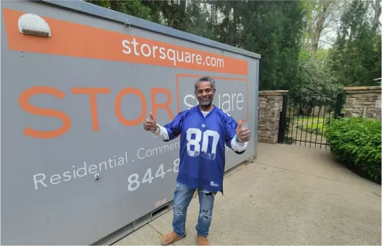 Customer standing beside a STORsquare storage container giving a thumbs-up gesture at a residential property in North Carolina.