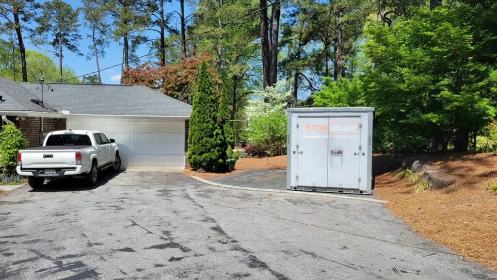 Portable storage container in a residential driveway showing how mobile storage saves money during moves