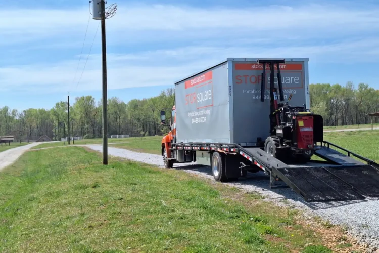 Delivery truck unloading a STORsquare portable storage container at a rural property