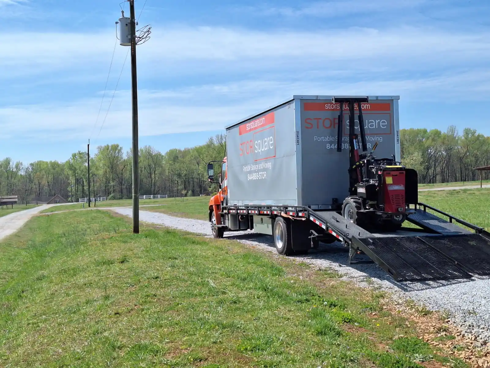 Delivery truck unloading a STORsquare portable storage container at a rural property