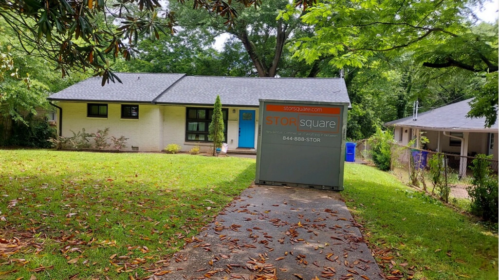 Portable storage container outside a home during moving day preparation