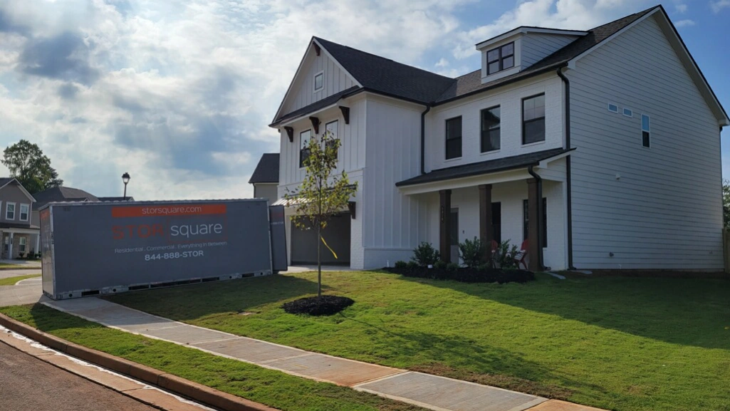Portable storage container for work relocation outside a suburban home ready for loading