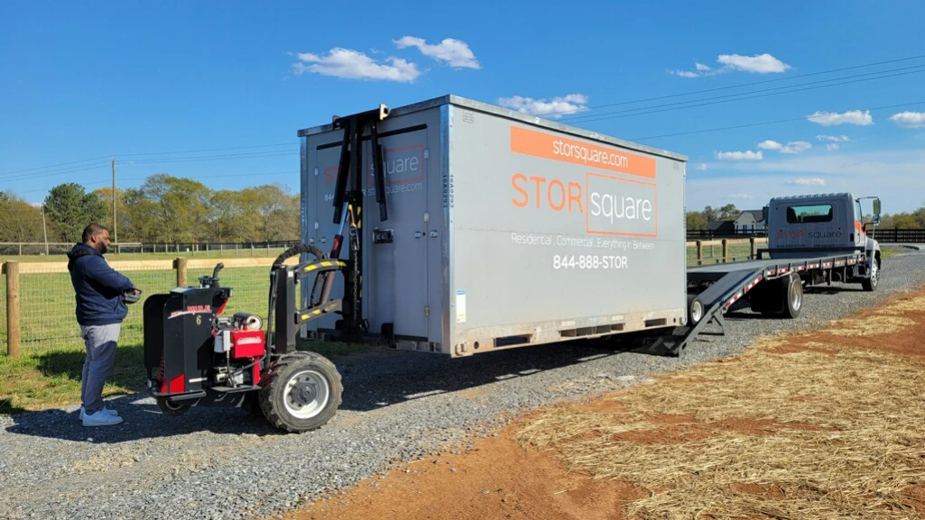 portable storage container being placed at a restoration job site to support crews and equipment staging
