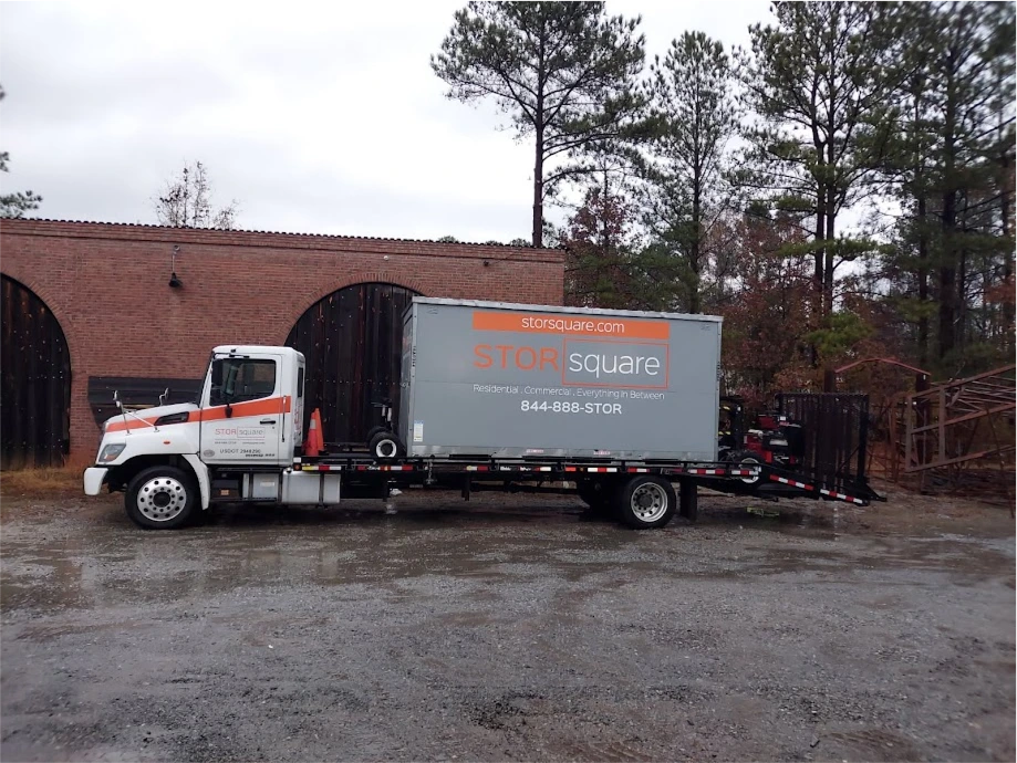 STORsquare mobile storage container on a delivery truck at a Huntersville NC site during rainy conditions.