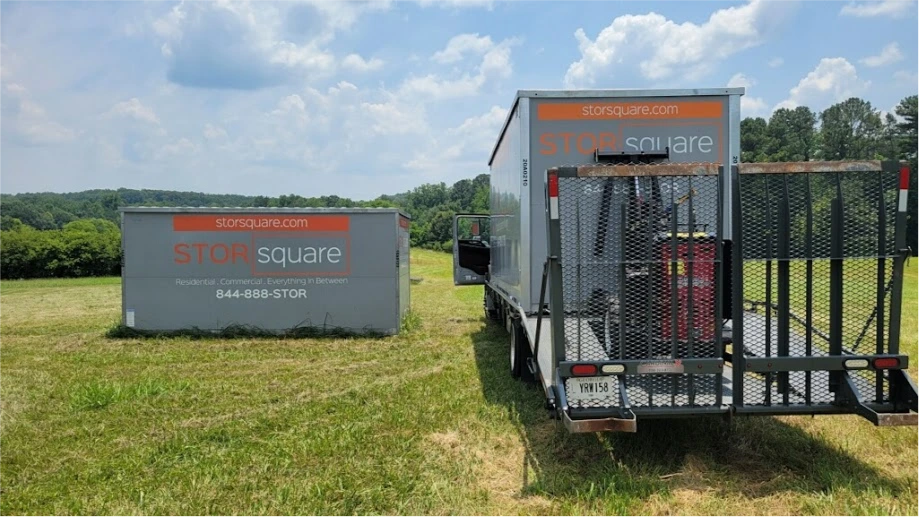 STORsquare portable storage containers in an open grassy area in Lakeland, FL, with delivery equipment on-site.