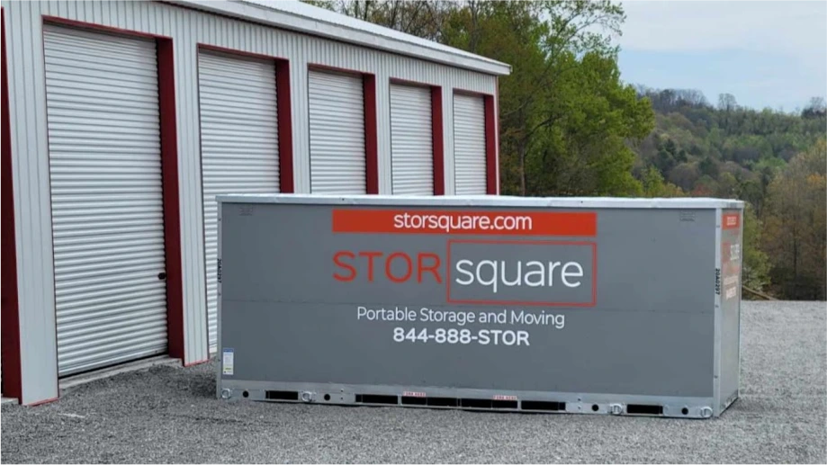 STORsquare portable storage unit placed beside a self-storage building on a gravel lot in Lakeland, FL.