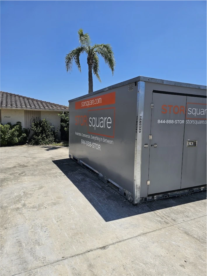 STORsquare portable storage container placed in a Huntersville NC driveway beside a home on a sunny day.