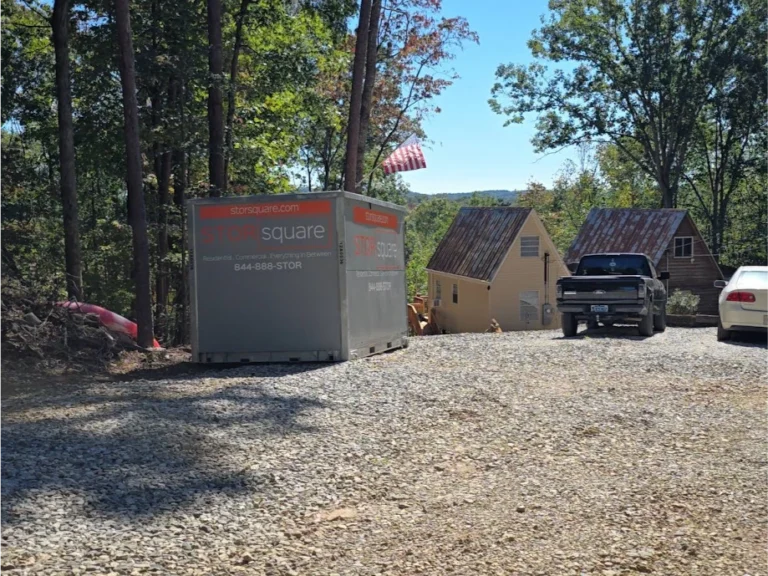 STORsquare portable storage container placed in a Plant City FL rural driveway near homes and wooded surroundings.