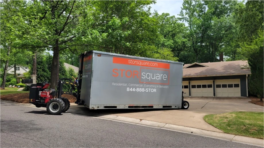 STORsquare portable storage unit being positioned curbside in a Woodstock GA neighborhood using lift equipment.