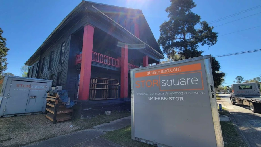 STORsquare storage containers placed outside a Mooresville NC residential property near a house and delivery truck.