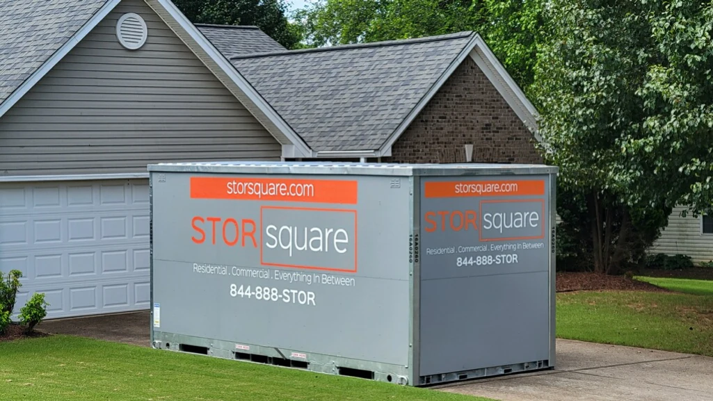 portable self storage units placed beside a home to help free up closet space