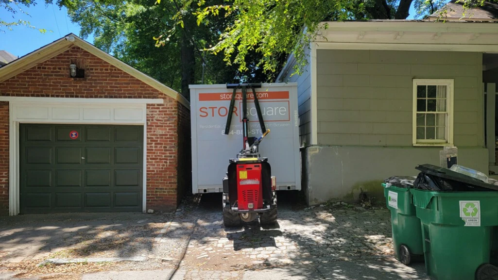 Storage container rentals nearby delivered to a residential driveway for easy home decluttering and storage