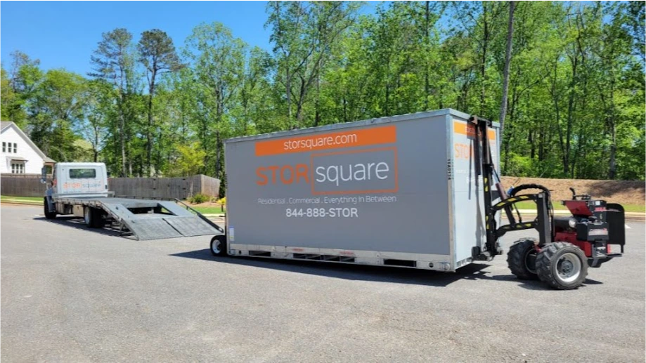 STORsquare mobile storage units being positioned in a Belmont NC neighborhood using delivery and placement equipment