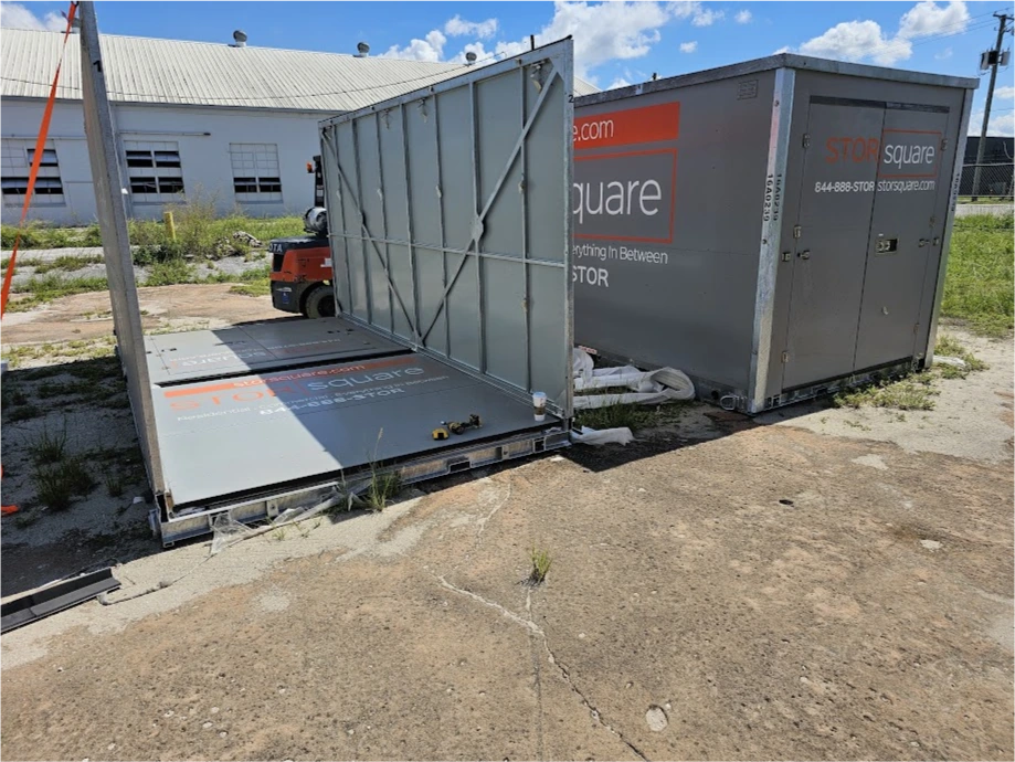 STORsquare mobile storage container being assembled in Hickory NC with open panel and equipment visible at a yard location.
