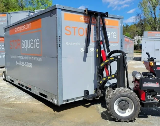 STORsquare mobile storage container positioned in a Hickory NC yard using delivery equipment with multiple units visible.