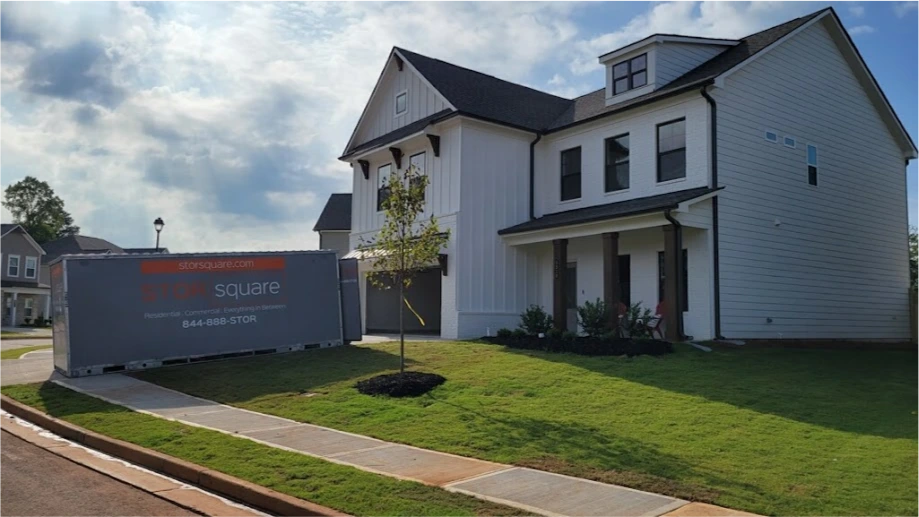 STORsquare mobile storage units placed beside a residential home in Davenport, FL with driveway and front yard visible.