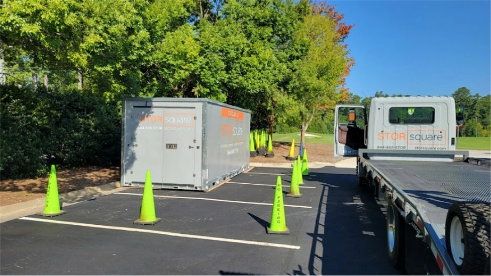 STORsquare mobile storage units placed in a Kannapolis parking lot beside a delivery truck and marked cones