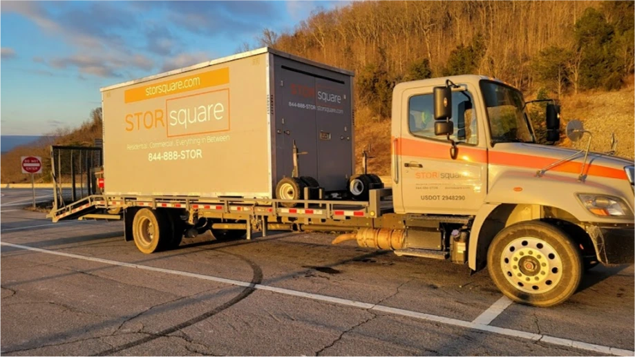 STORsquare mobile storage unit loaded on a delivery truck in Canton, GA ready for transport along roadway