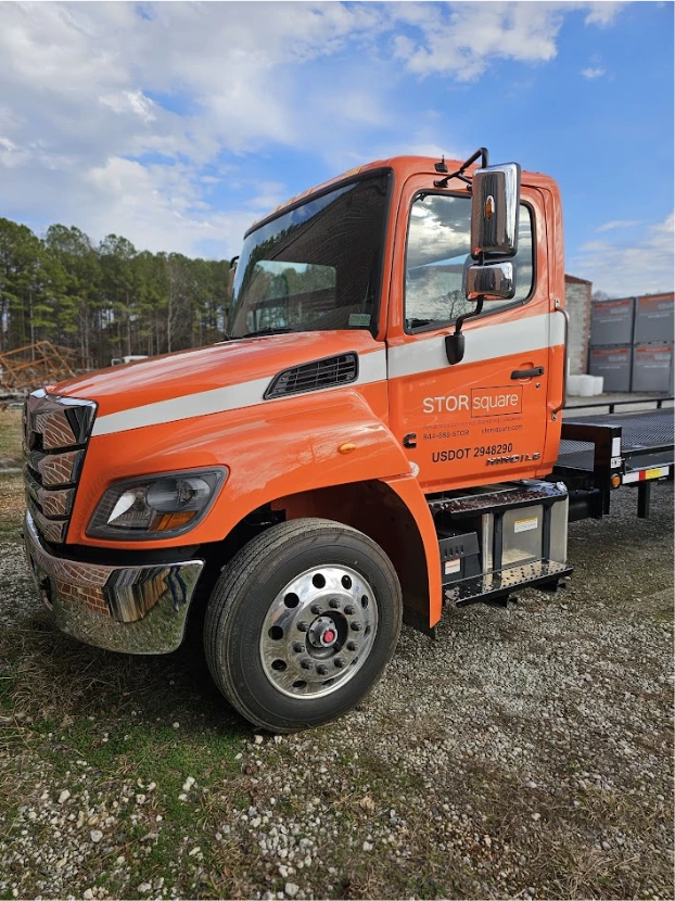 STORsquare moving container delivery truck parked at a Winder site with storage units visible in the background